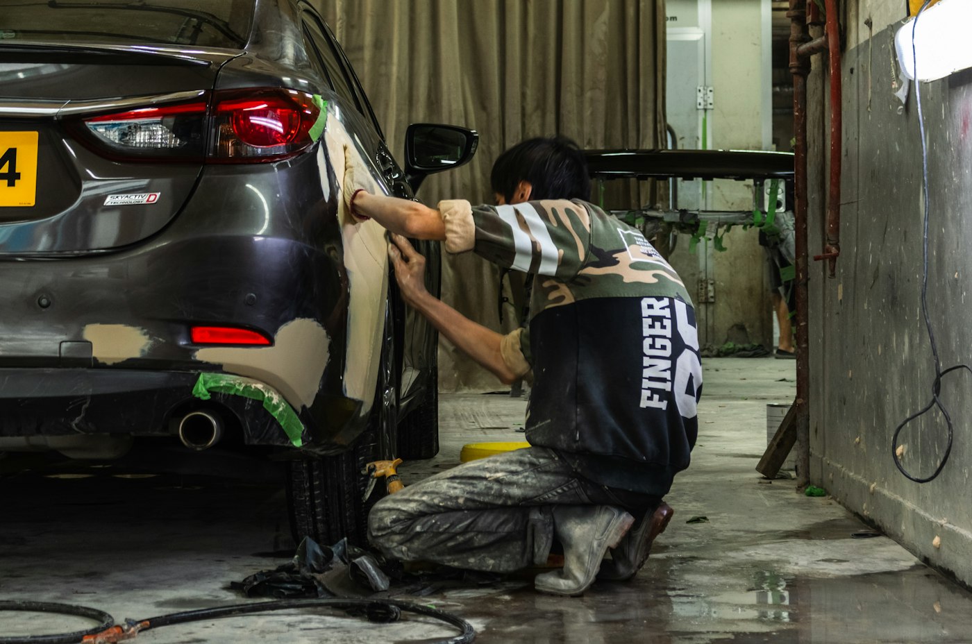 Technician working on a car body panel